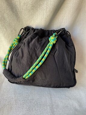 Black Drawstring Shoulder Bag with Green Accent Rope Strap